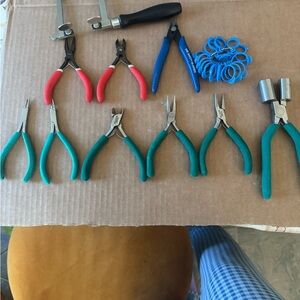 Jewelry making tool set with various pliers and wire cutters.